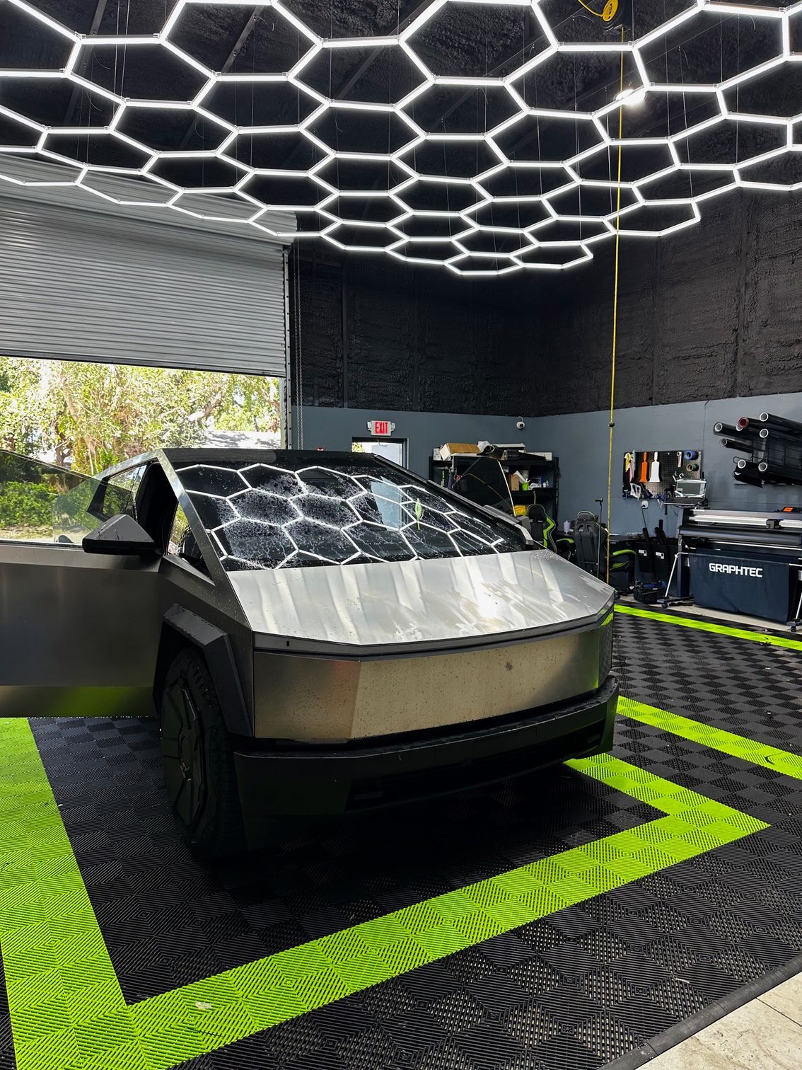 A tesla cybertruck is parked in a garage.
