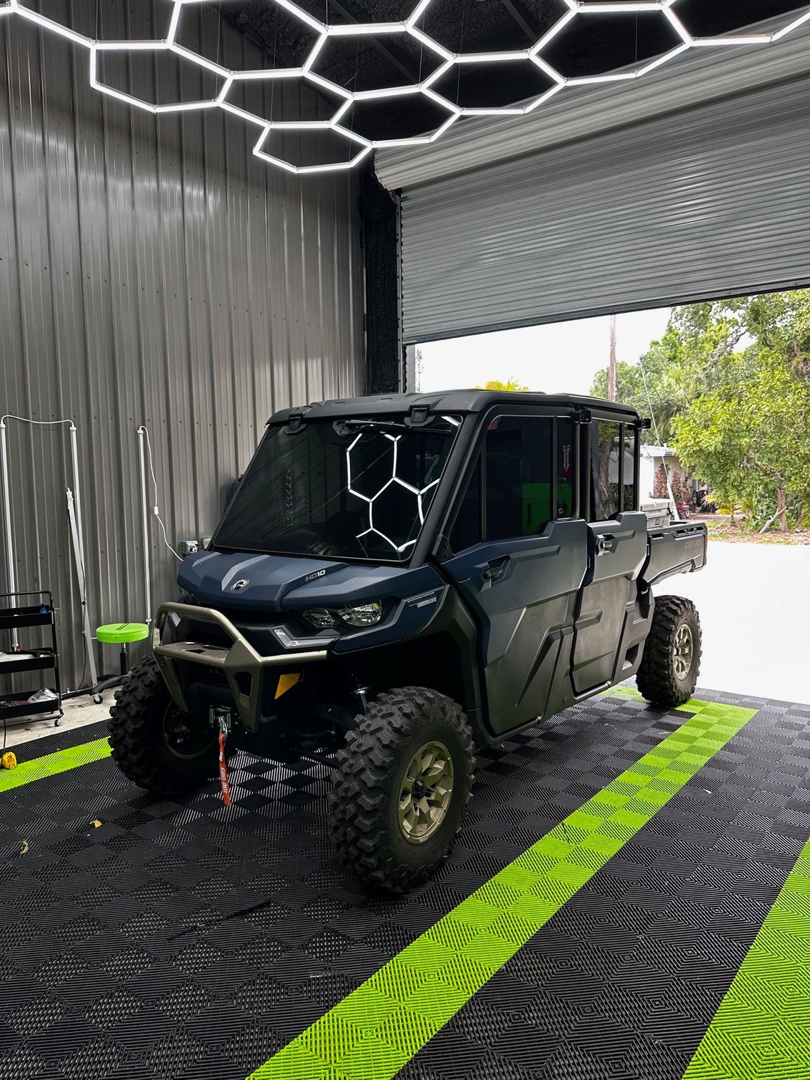 A blue atv is parked in a garage.