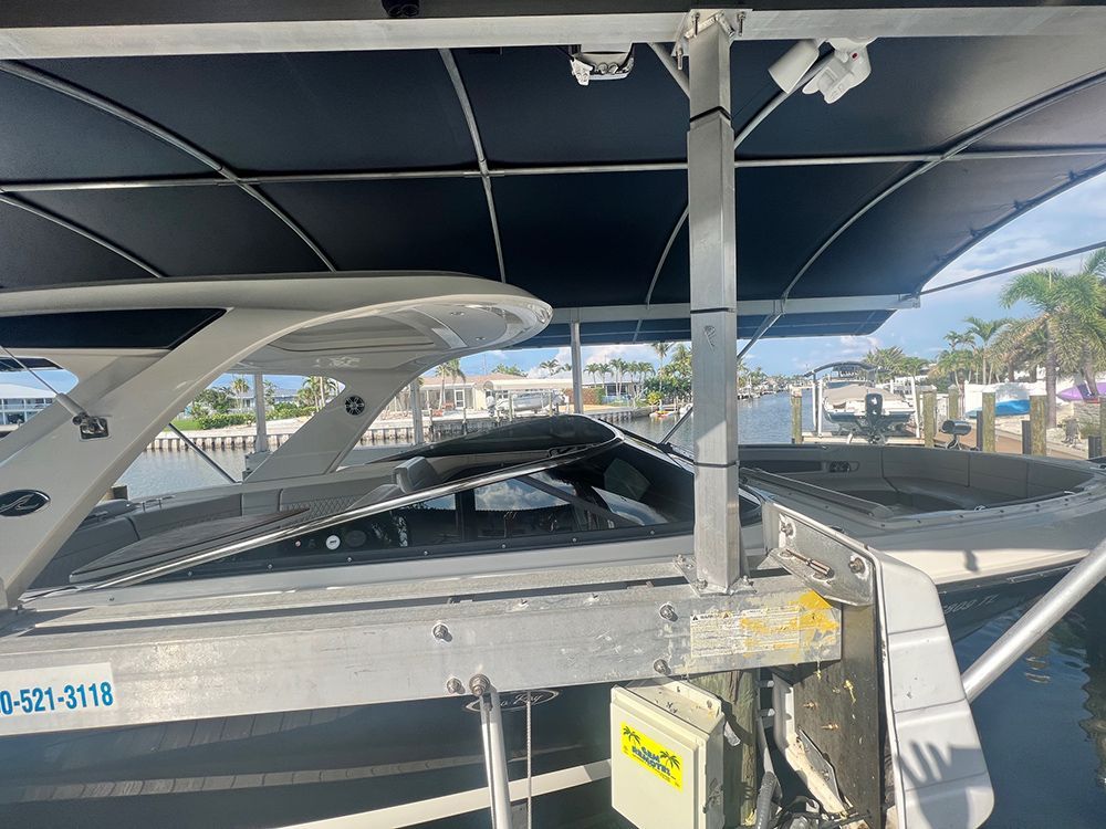 A boat with a canopy on top of it is docked in a marina.