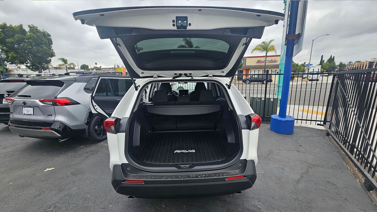White SUV with open trunk, parked outside