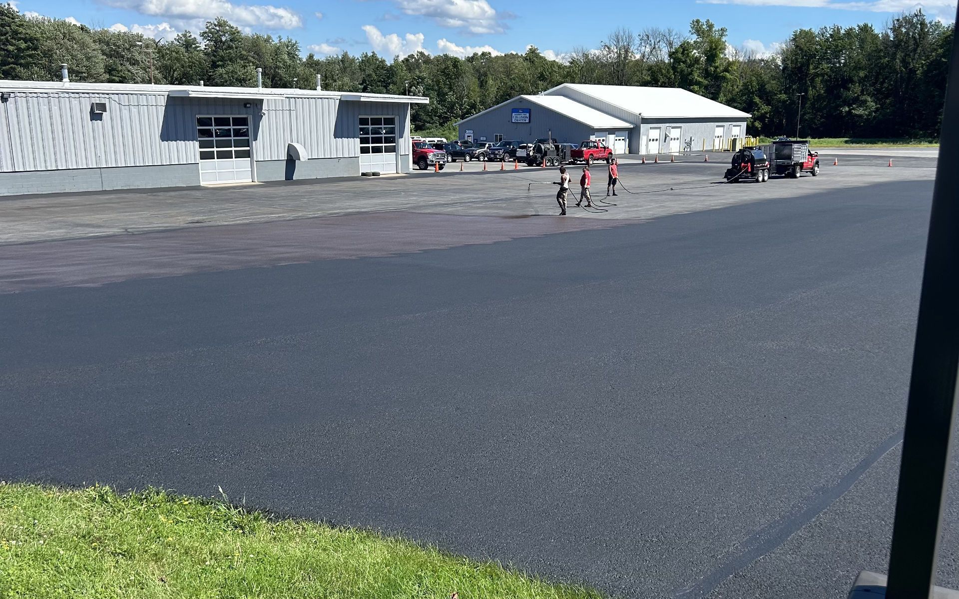 Large brick house with a landscaped yard and a long driveway.