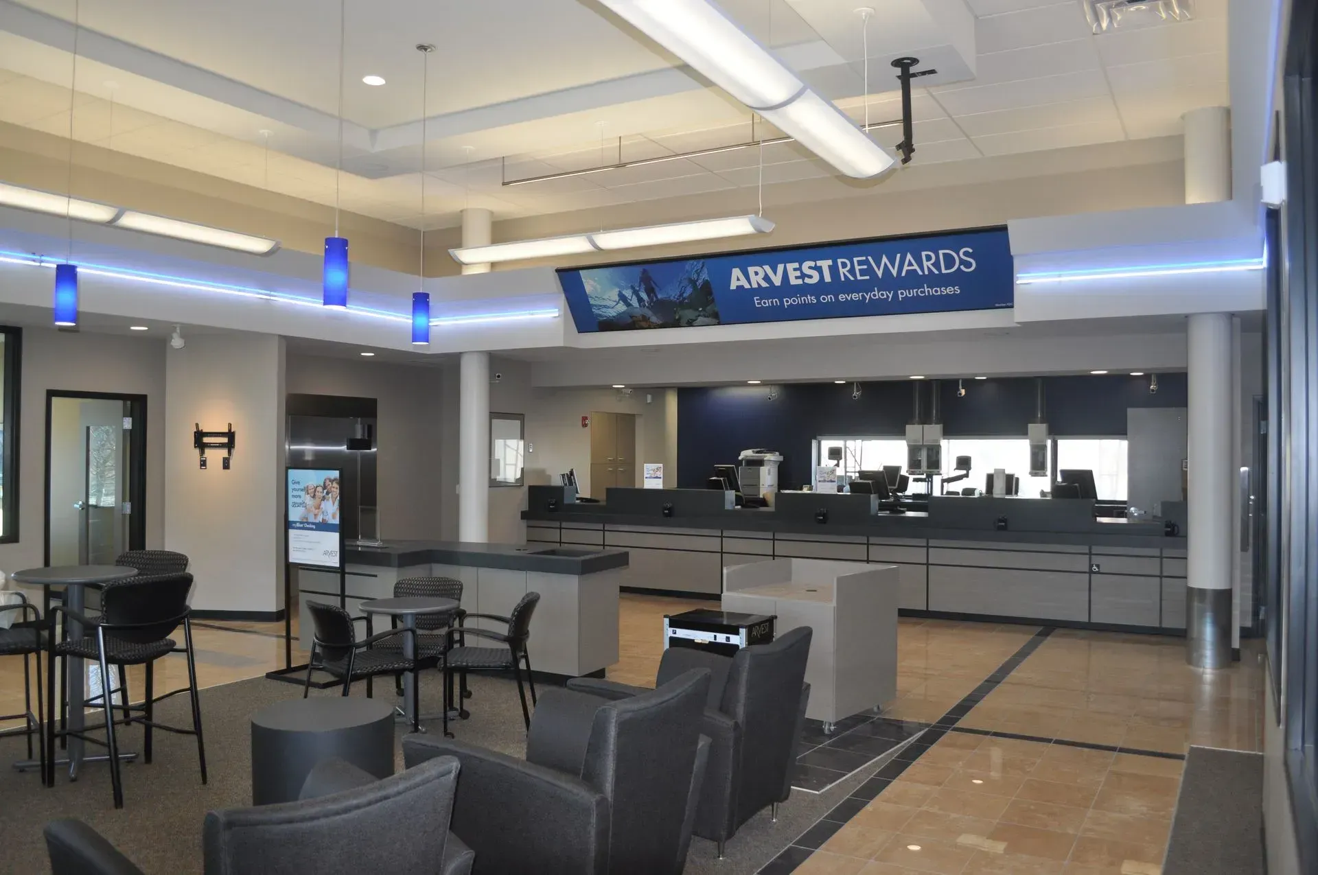 Bank interior with customer service counters, seating area, and 