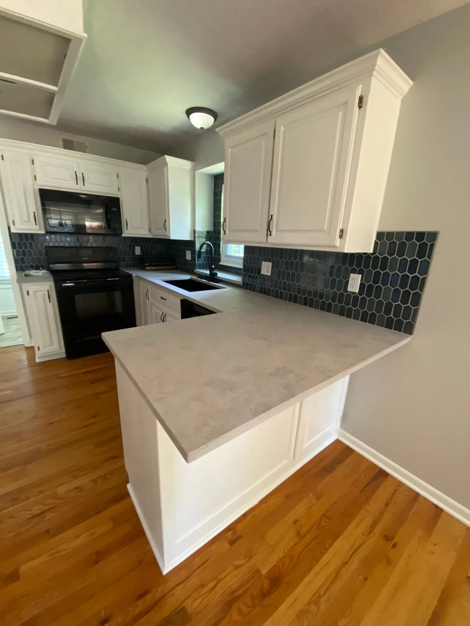Aerial view of a winding river flowing through a lush green forest.