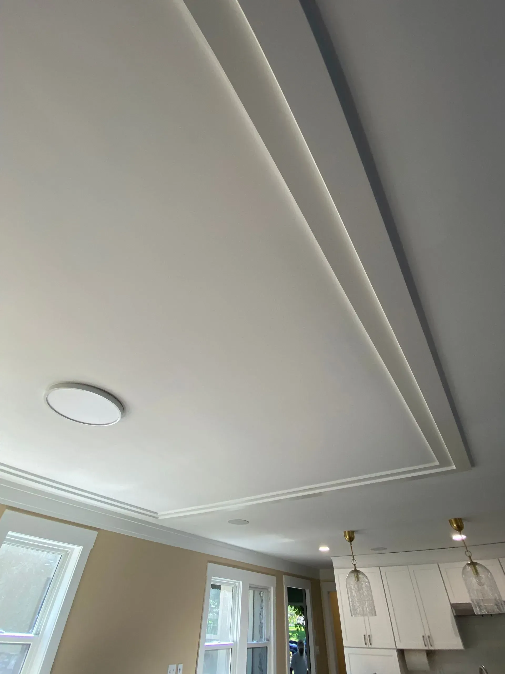 White ceiling with recessed lighting and crown molding.