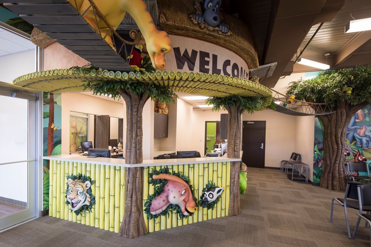 Jungle-themed reception desk with cartoon animals, 