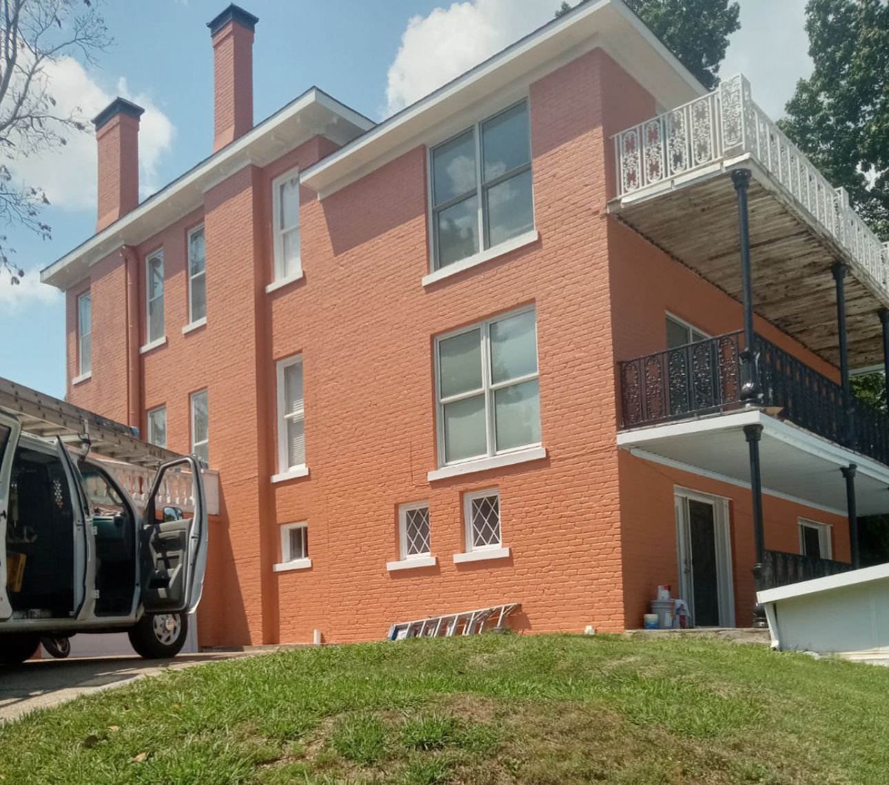 A brick building with a car parked in front of it
