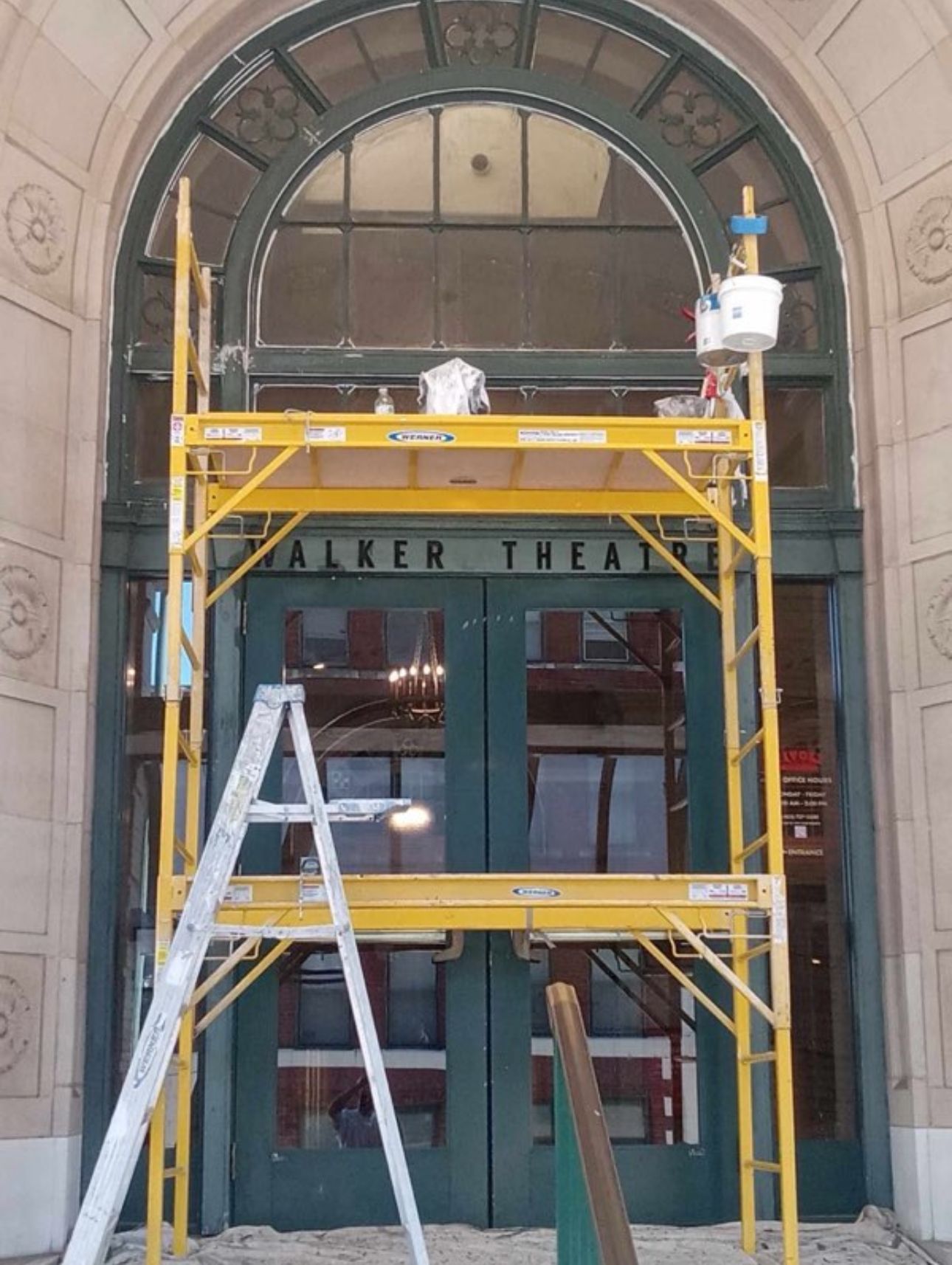 A yellow scaffolding in front of a building