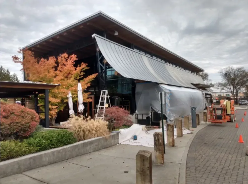 A large building with a roof that is covered in plastic.
