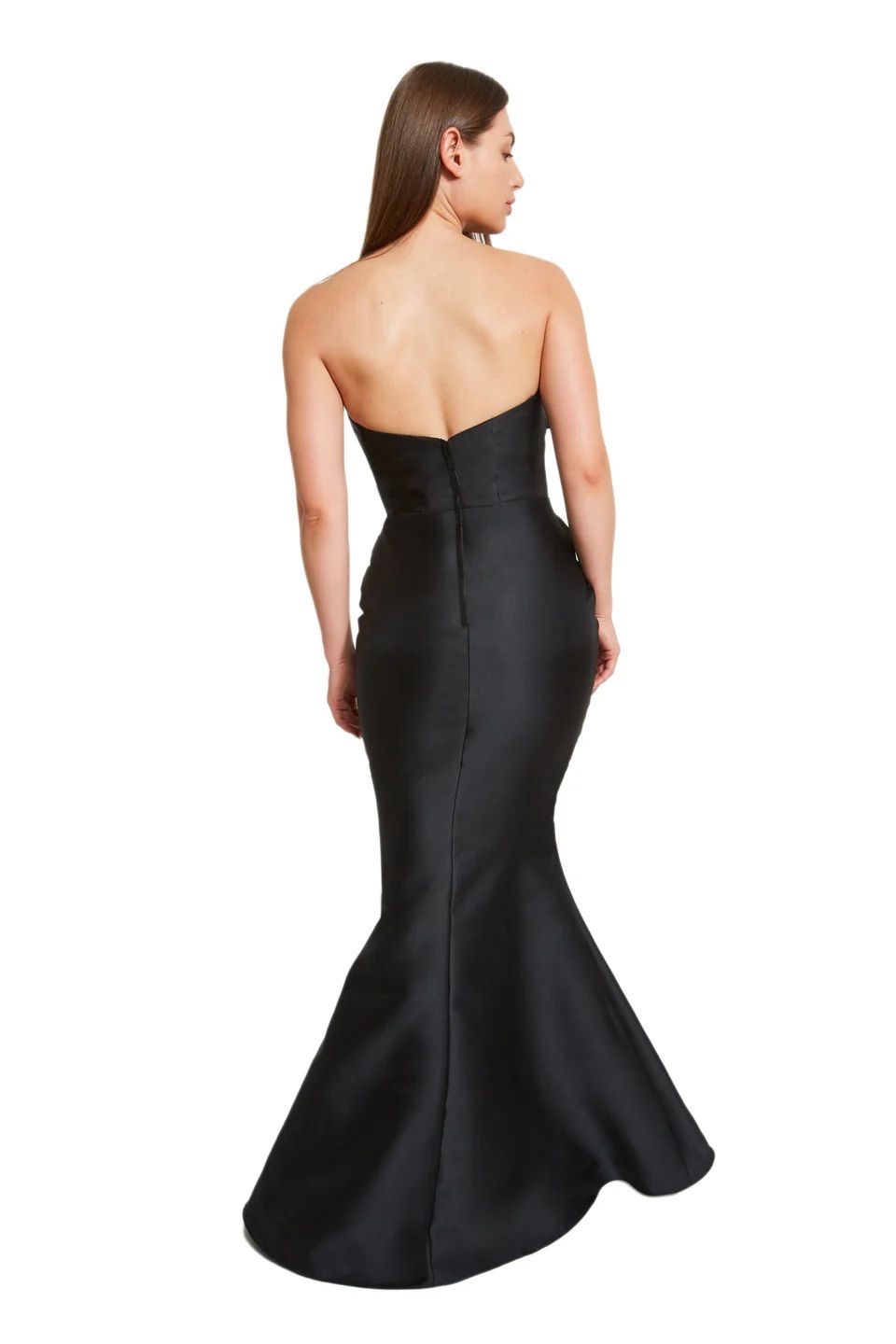 A woman is shown from the back, wearing a blue dress with a bow on the shoulder.