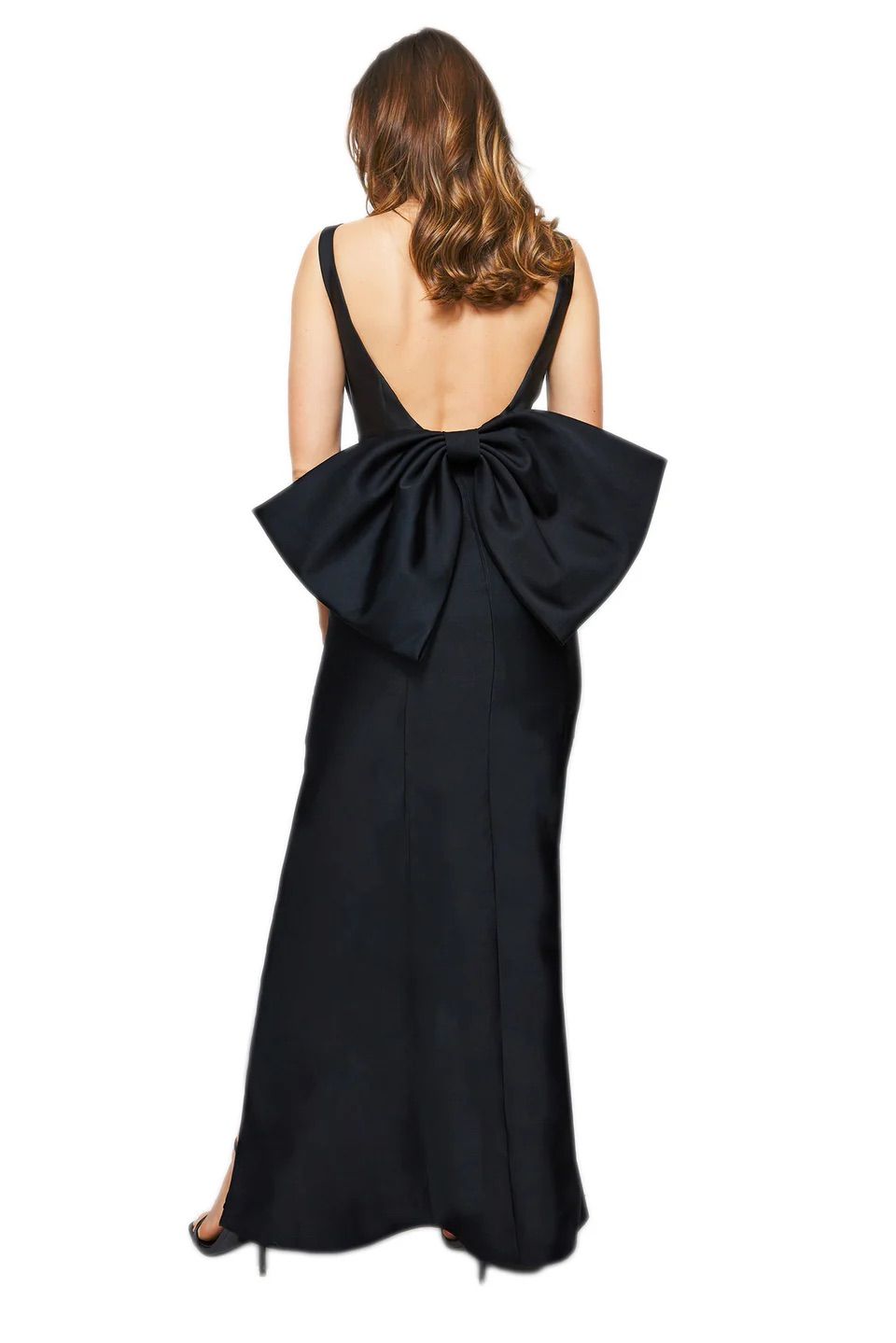 A woman is wearing a black dress with a large bow on the back.