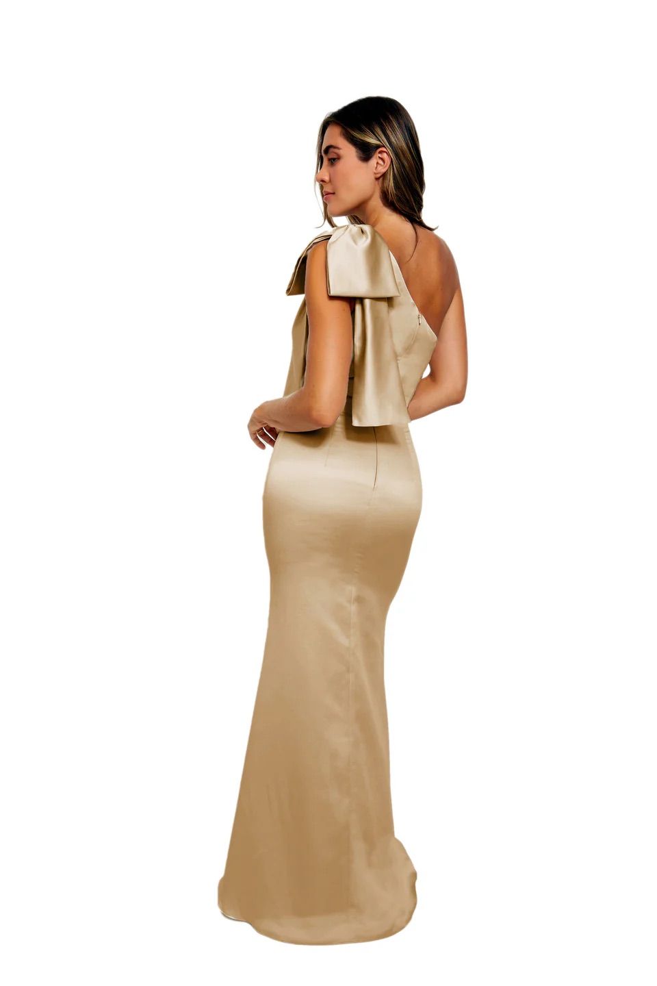 A woman is wearing a long satin dress with a bow on the shoulder.