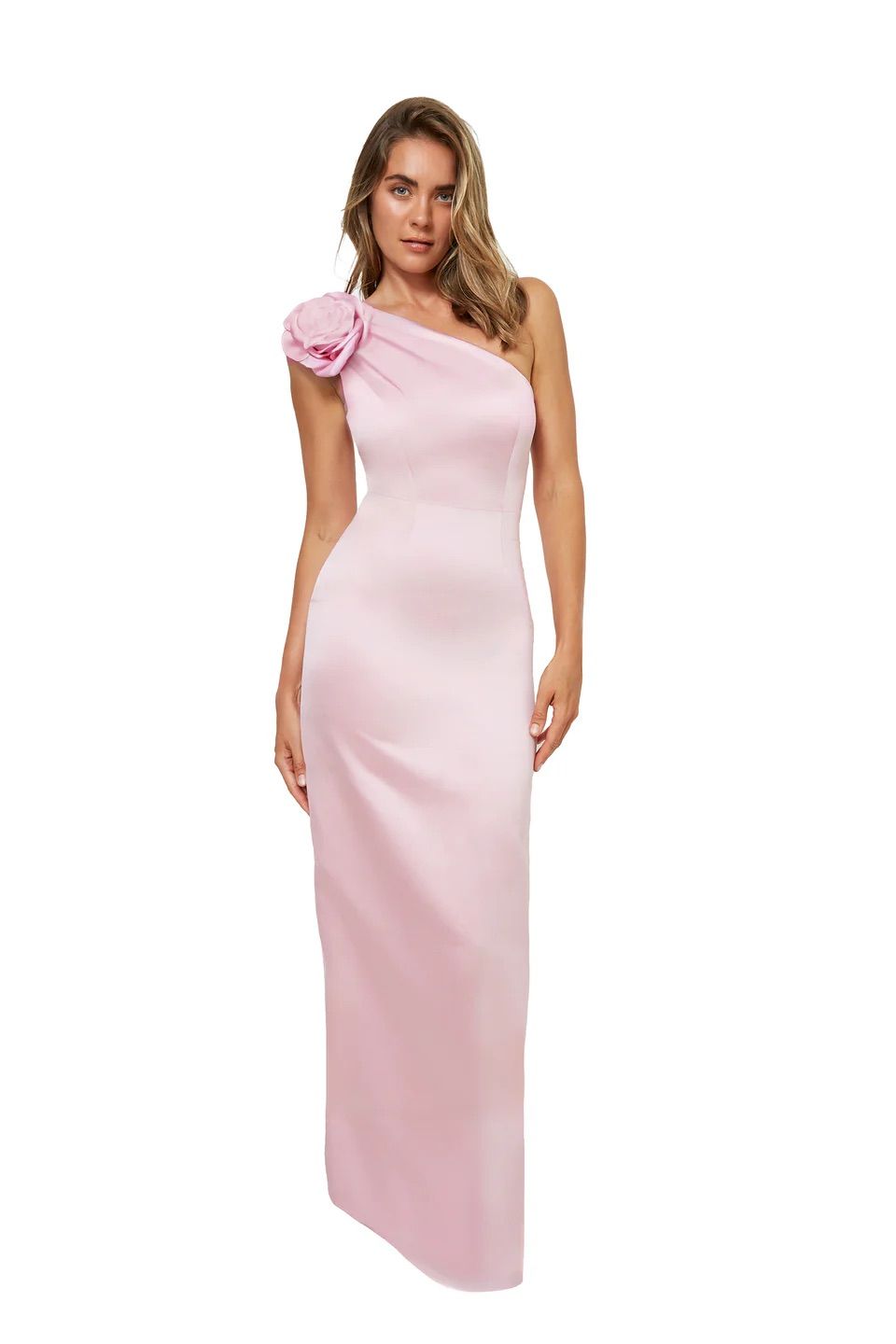 A woman is wearing a pink one shoulder dress with a flower on the shoulder.