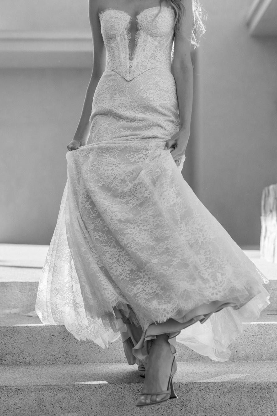 A black and white photo of a woman in a wedding dress.