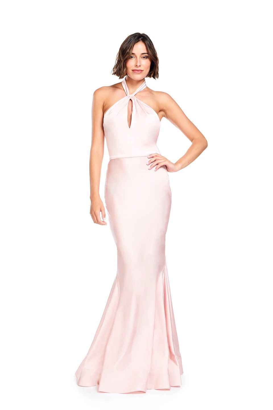 A woman is wearing a long pink dress with a halter neckline.