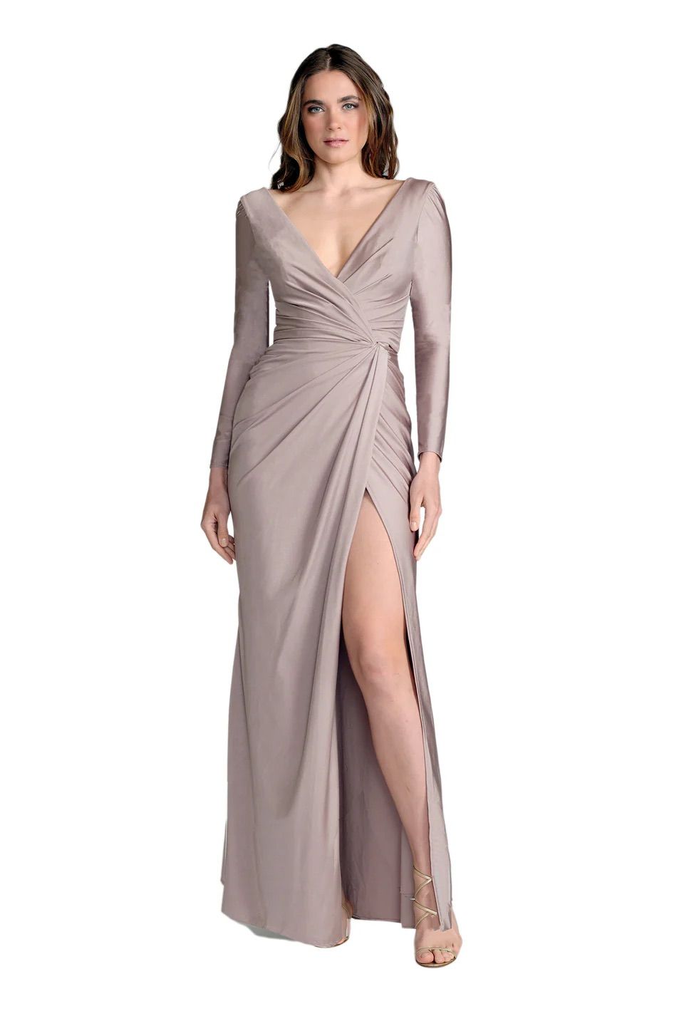 A woman is wearing a long dress with a high slit and long sleeves.