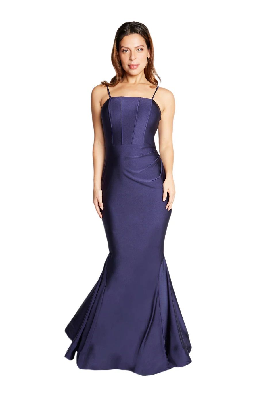 A woman in a long purple dress is standing on a white background.