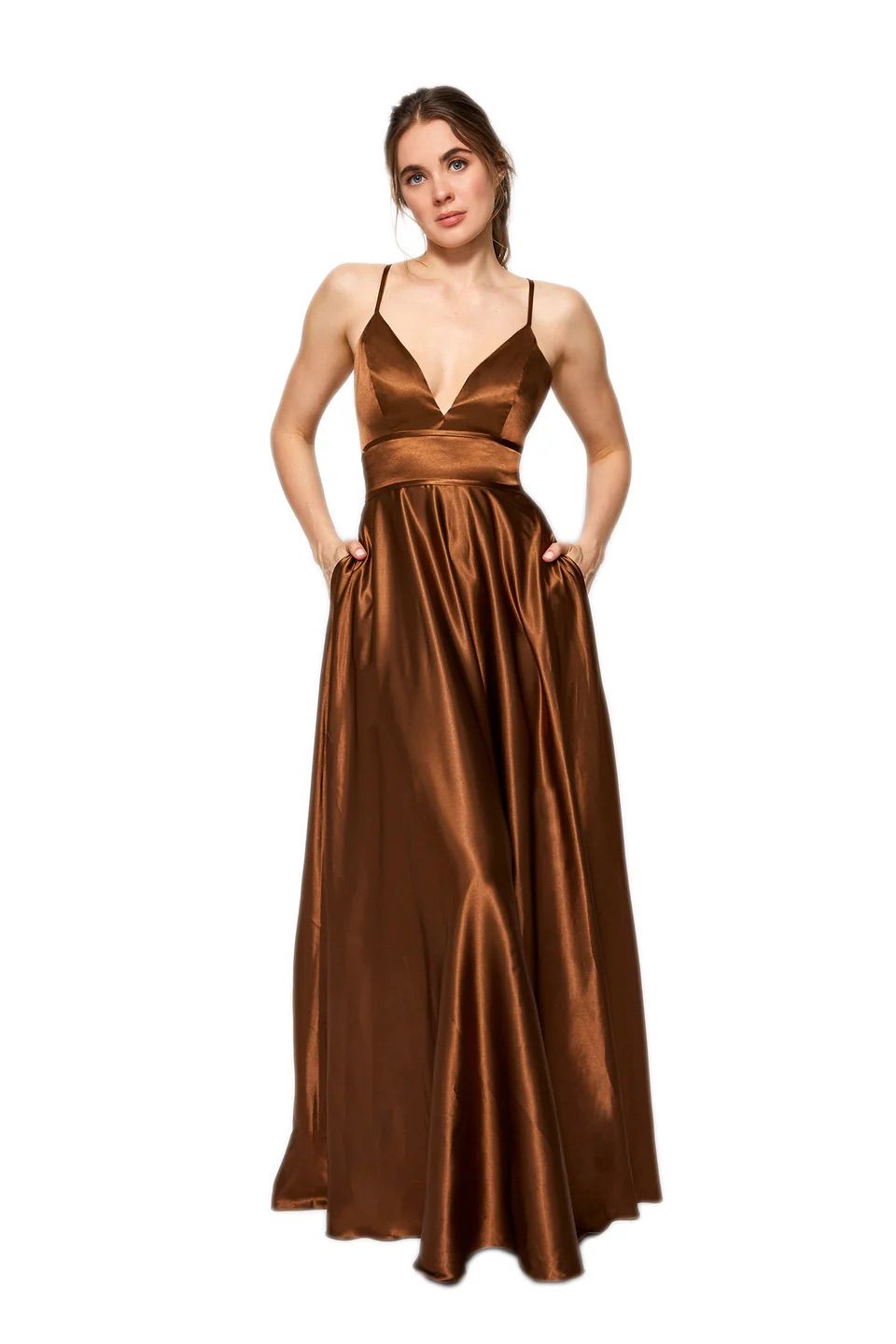 A woman is wearing a long brown satin dress with pockets.