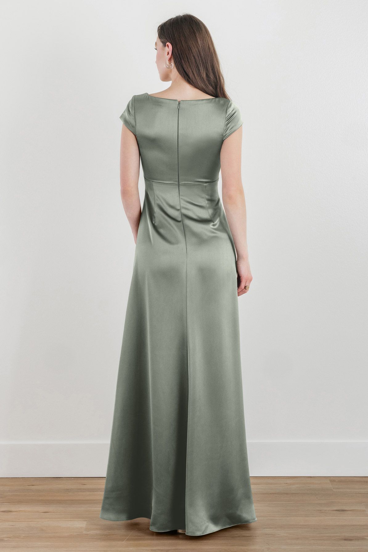 The back of a woman wearing a green satin dress.