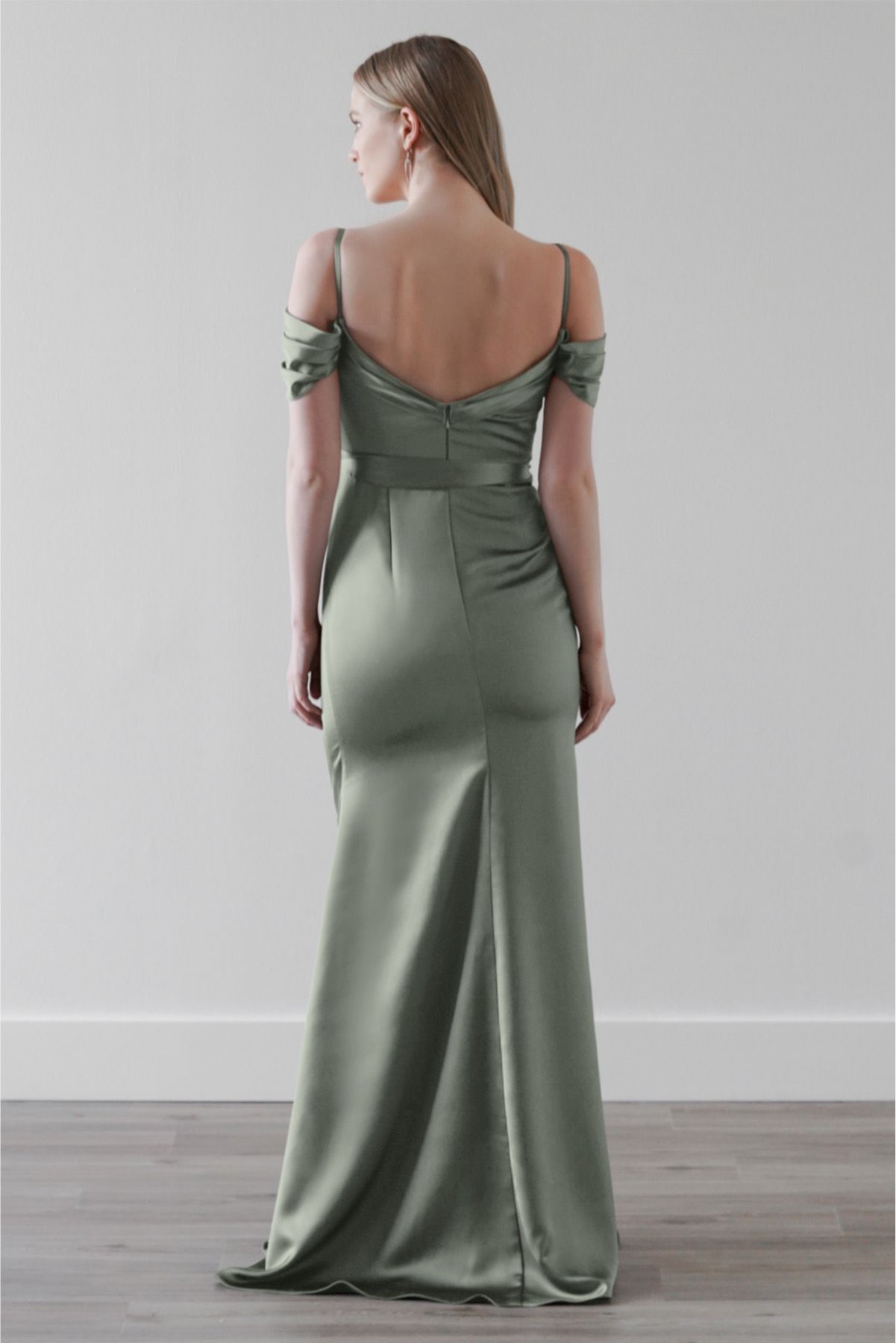 The back of a woman wearing a green bridesmaid dress.