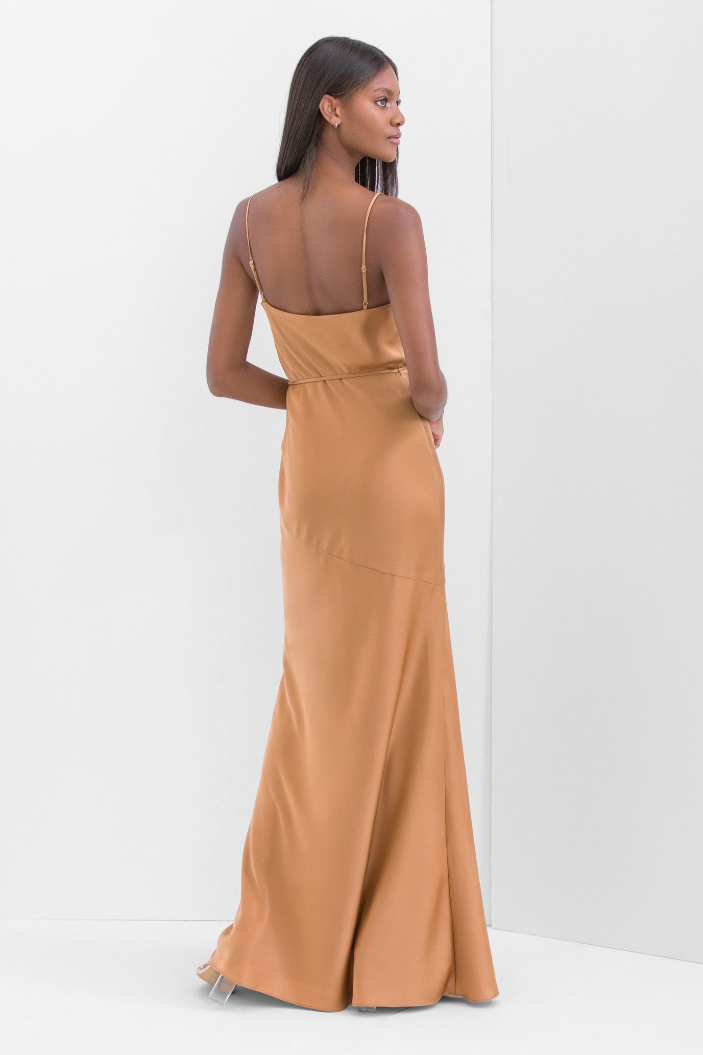 The back of a woman wearing a long brown dress.