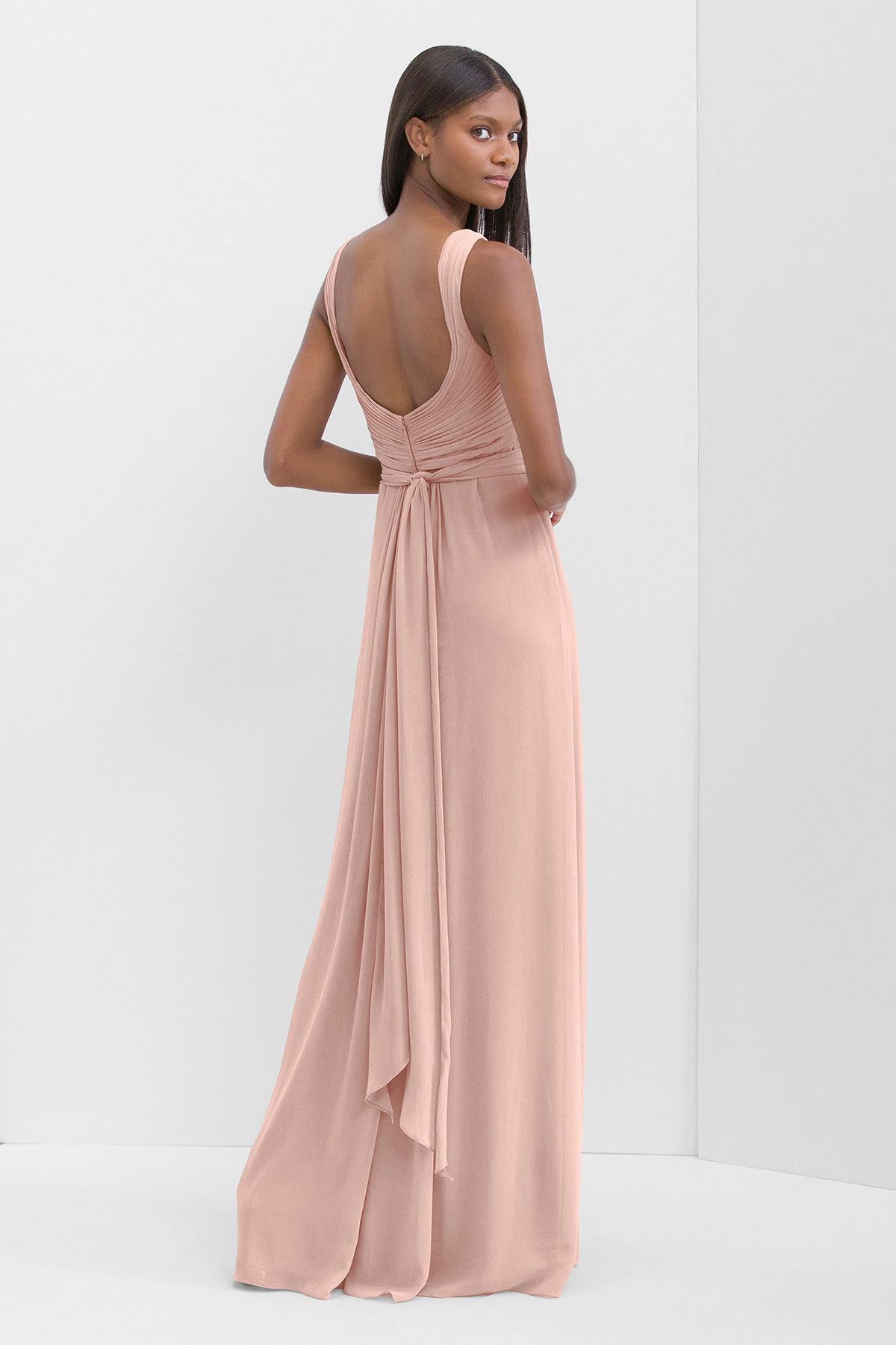 The back of a woman wearing a pink bridesmaid dress.