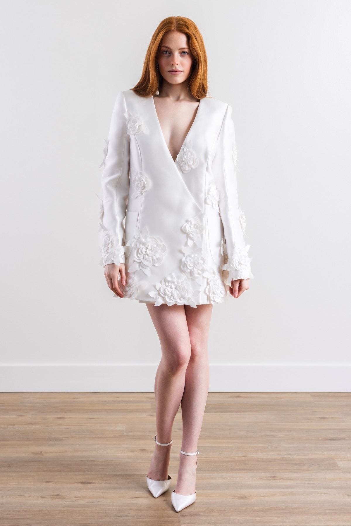 A woman is wearing a white dress and white shoes.