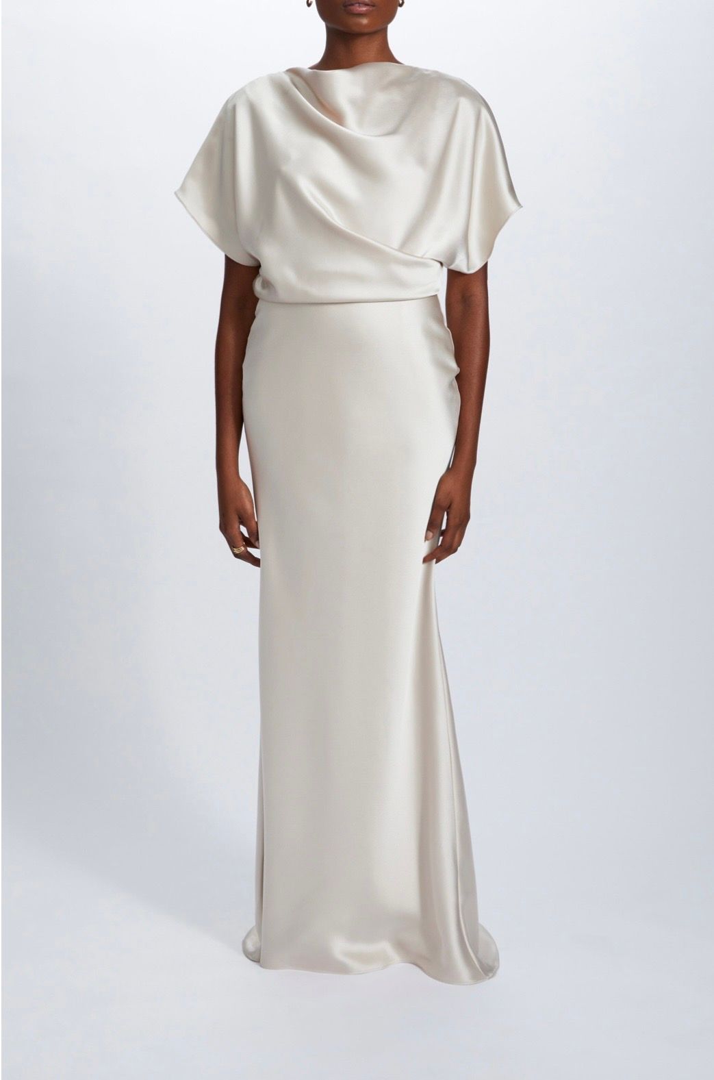 A woman is wearing a white satin dress with short sleeves.