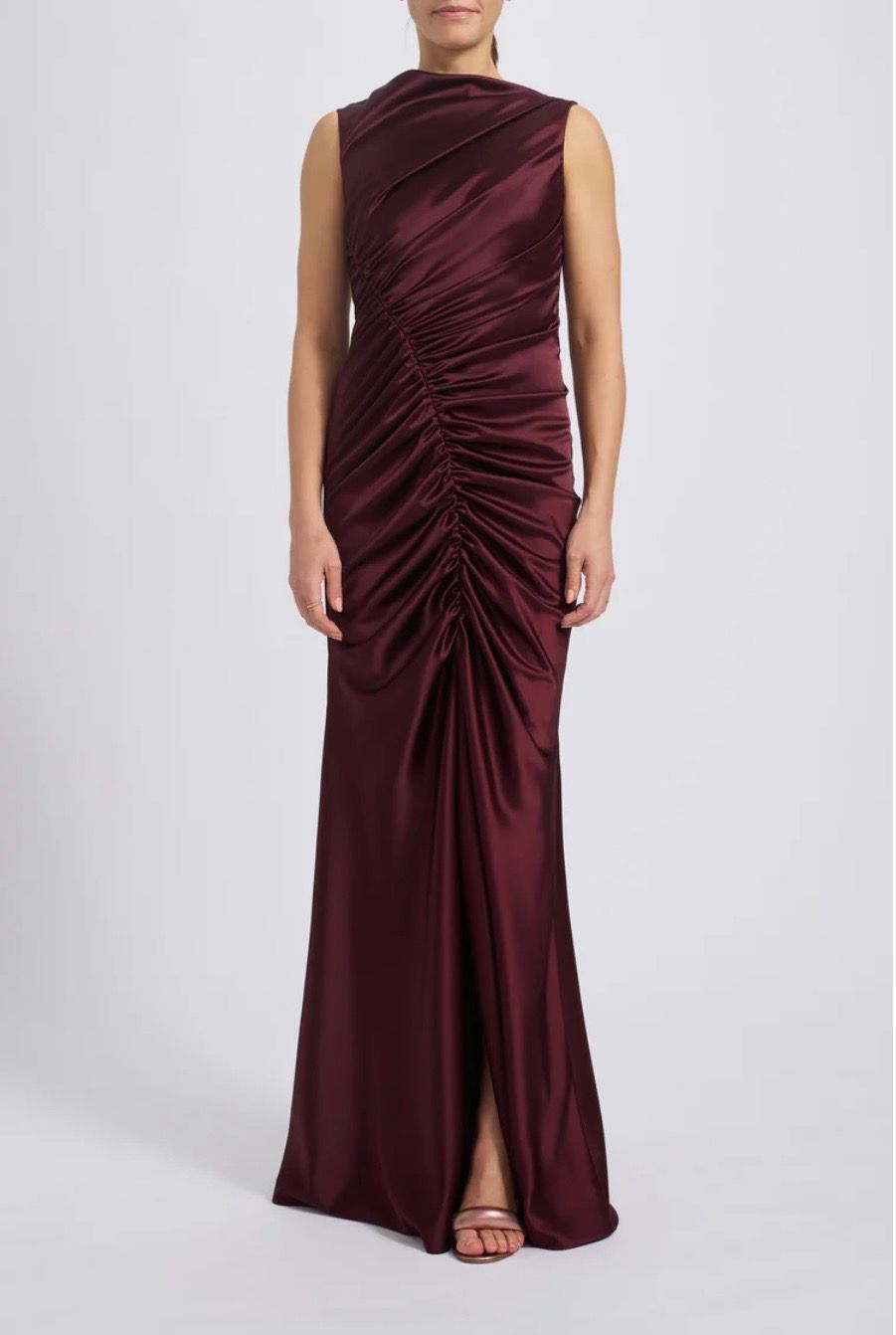 A woman is wearing a burgundy satin dress with a high neckline.