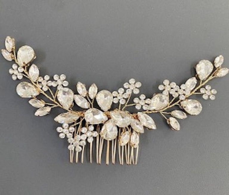 A hair comb with flowers and leaves on it