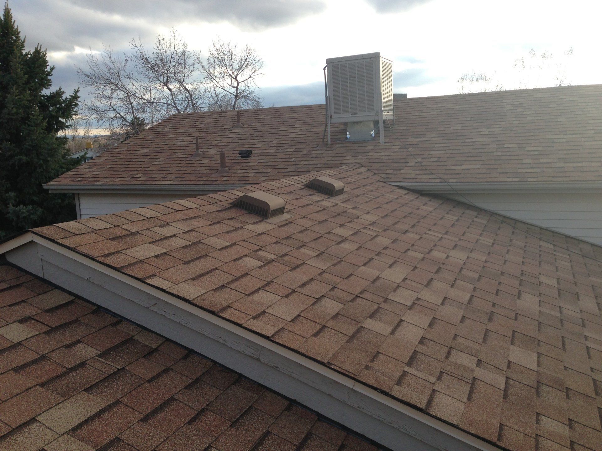 A roof of a house with a fan on top of it