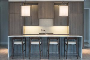 A kitchen with a large island and stools.