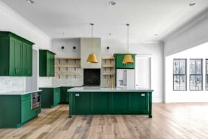 A kitchen with green cabinets and a large island