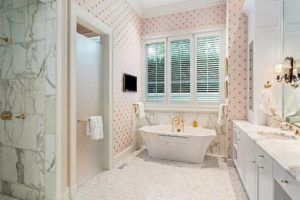A bathroom with a tub , sink , and shower.