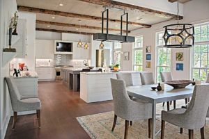 There is a dining table and chairs in the middle of the room.