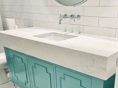 A bathroom vanity with a sink and a mirror.