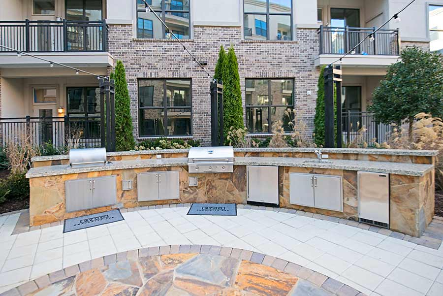 There is a large outdoor kitchen in front of a building.