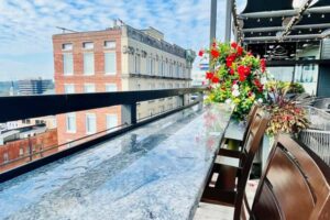 A balcony with a view of a city and a building in the background.