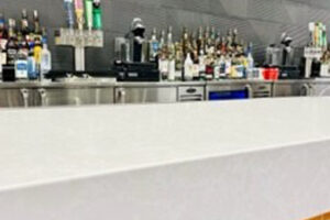 A bar with a lot of bottles of alcohol on it.