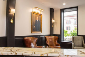 A room with chairs and a painting on the wall