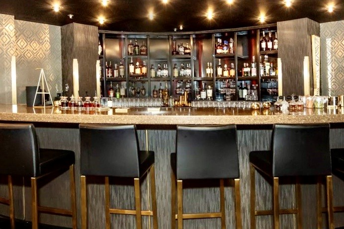 A bar with a lot of bottles on it