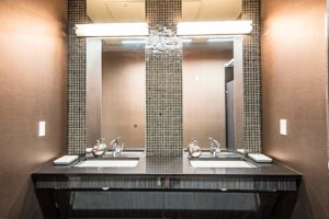 A bathroom with two sinks and two mirrors.
