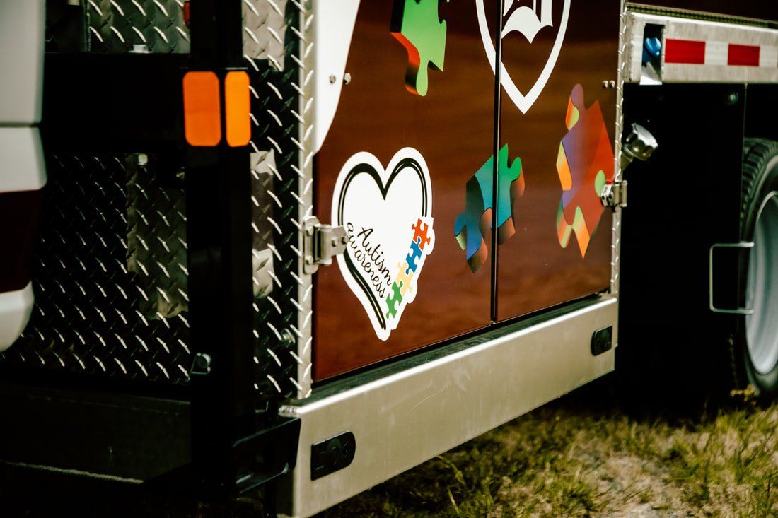 A truck with a heart and puzzle pieces on it