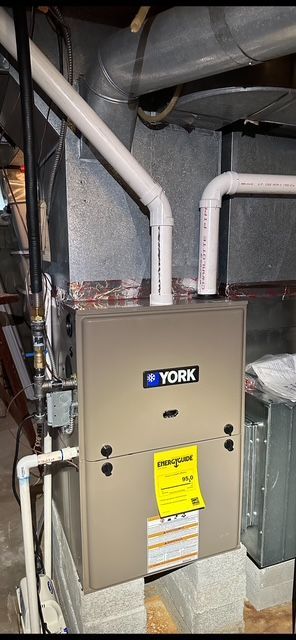 A york heating and cooling system is installed in a basement.