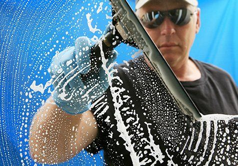 man cleaning window
