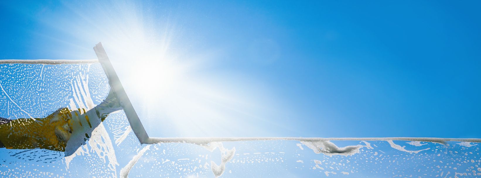 Snowy ski lift chair in bright sunshine over a winter landscape