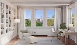 Bright minimalist living room with white shelves, sofa, desk, and large windows overlooking trees