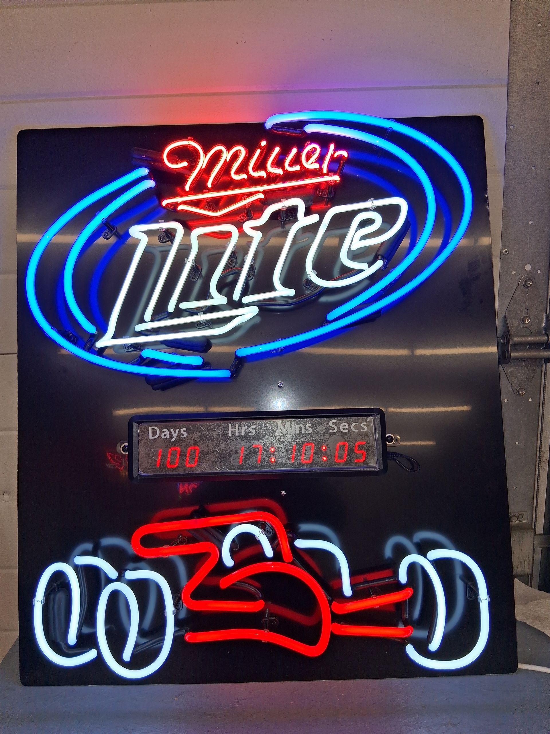 Neon Miller Lite sign with blue and red lights and a small digital clock display