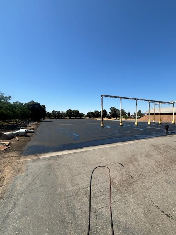 A large empty parking lot with a blue sky in the background