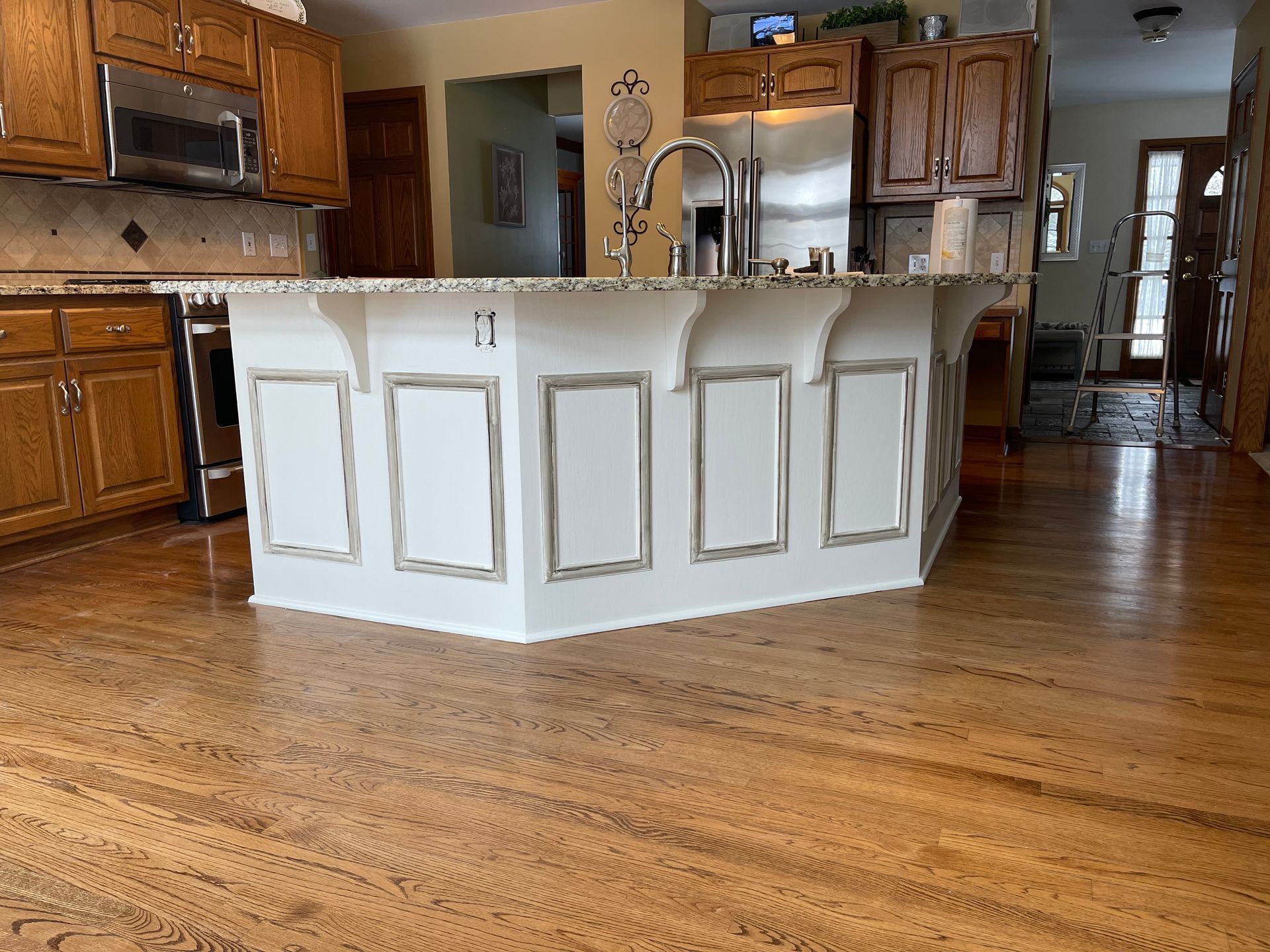 A kitchen with a large island in the middle of it - after