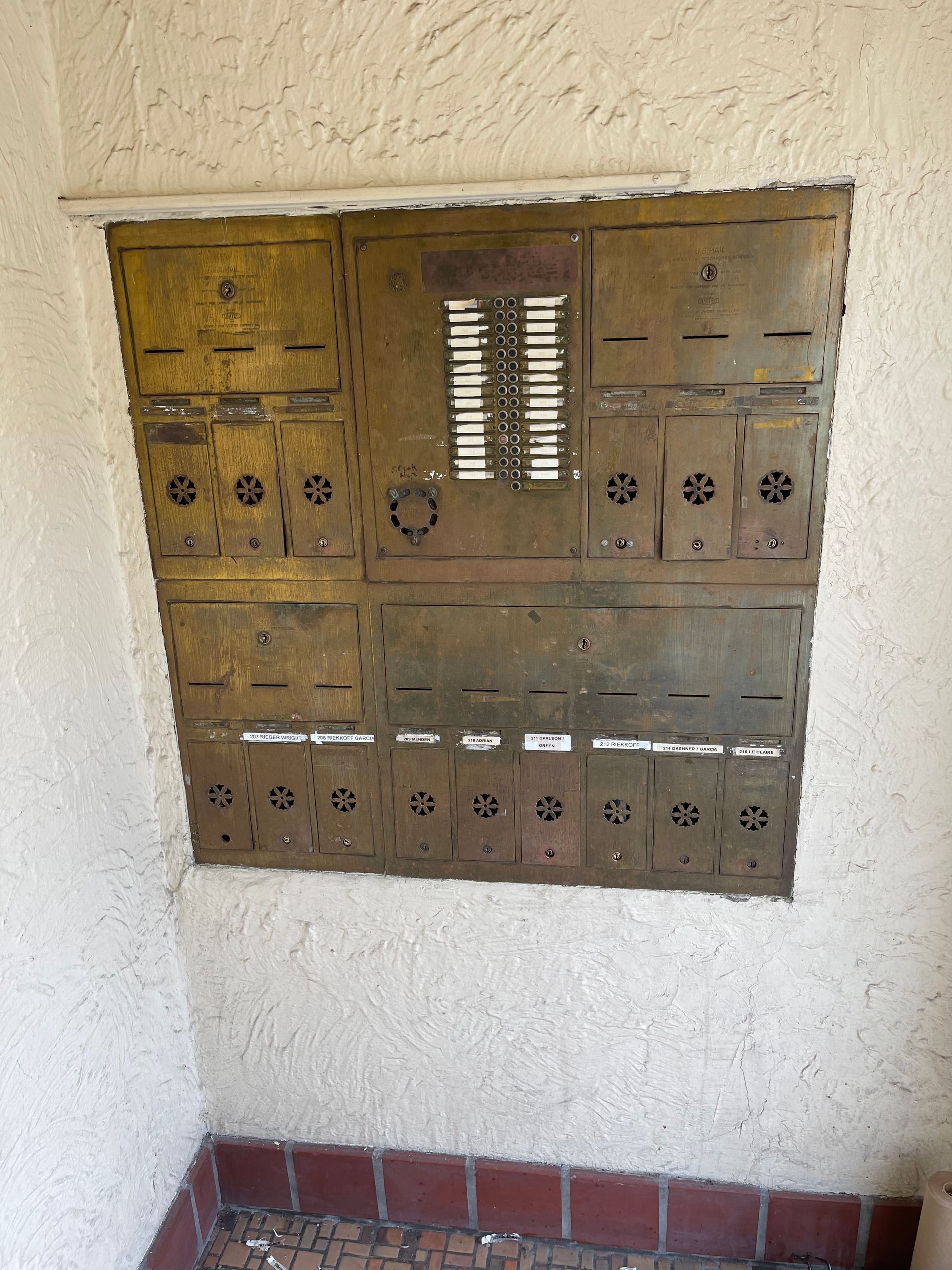 A wall with a bunch of mailboxes on it - before